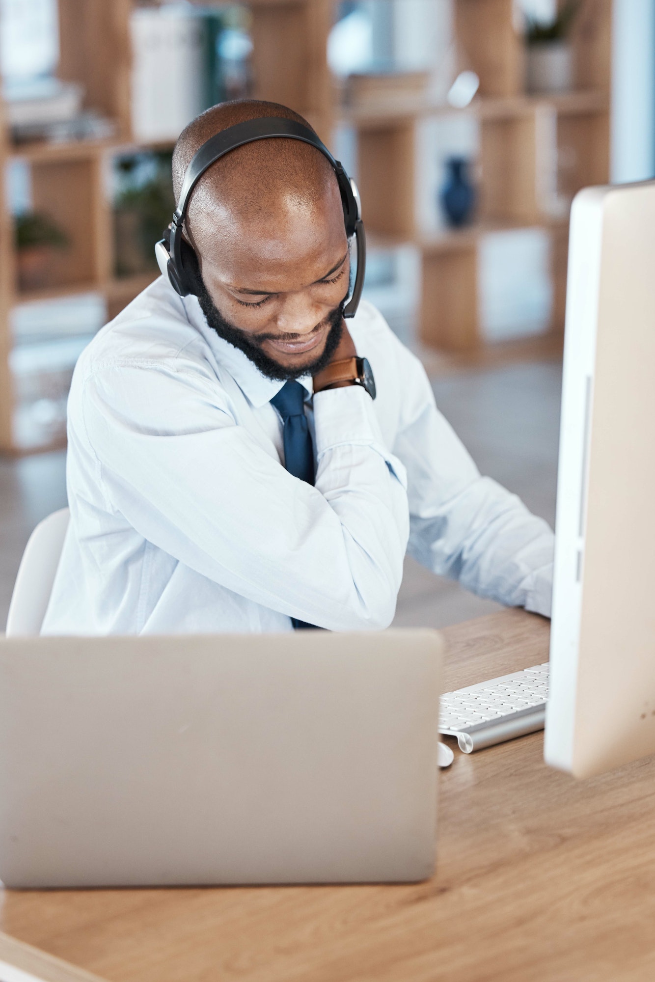 Black man, call center and neck pain by computer for tech support, communication and crm help desk.